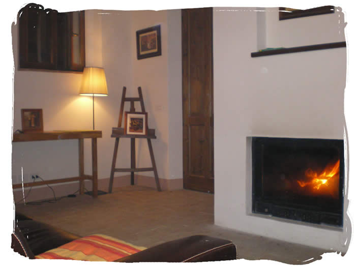 Downstairs living room with fireplace providing underfloor heating to the whole property